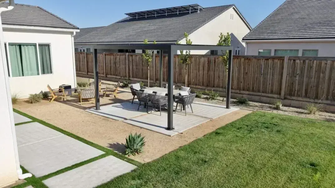 Backyard patio featuring a pergola and dining set