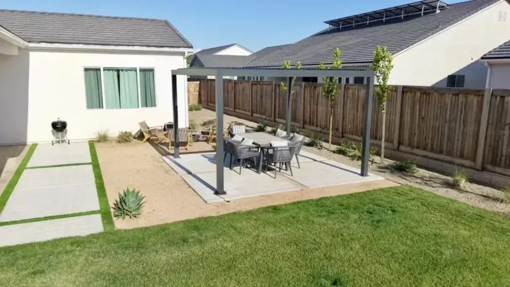 Backyard patio featuring a pergola and dining set